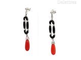 two pairs of earrings with black and red stones on them
