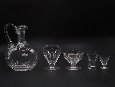 five glasses and a decanter on a table
