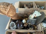 a cardboard box filled with assorted items and a statue of an owl