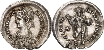 a silver coin with an image of a woman and a man on it
