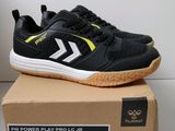a close up of a pair of black and yellow shoes on top of a box