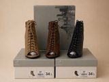three pairs of women ' s shoes on display in a box