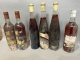 several bottles of wine are lined up on a table