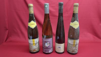 three bottles of wine are lined up on a red background