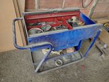 a blue cart with tools in it sitting on the ground