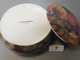 a bowl with a lid that is sitting on a table