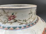 a white vase with a floral design on it