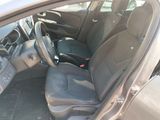 the interior of a car with the door open and the driver ' s seat down