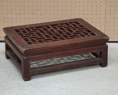a small wooden table with a lattice design on it