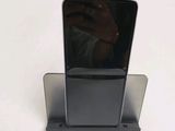 a phone that is sitting on a stand on a table