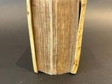 a small wooden vase with a book inside of it