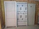 three doors in a room that are covered with plastic