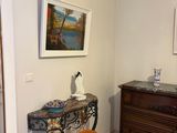a table with a vase on it and a dresser in the background
