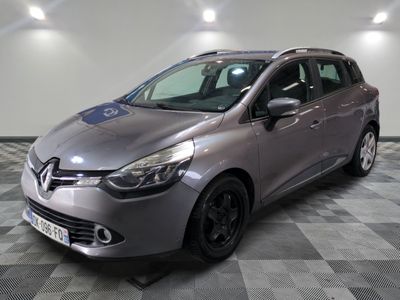 a grey car is parked in a room with a checkered floor