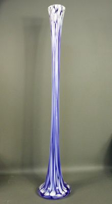 a tall glass vase that is sitting on a table