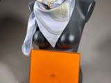 a mannequin with a scarf on it and an orange box