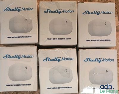 six small boxes of small motion motion balls on a wooden surface