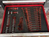 a tool drawer with tools in it in a garage