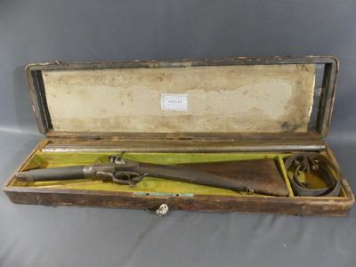 an old gun in a wooden case on a grey background