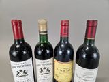 several bottles of wine are lined up on a table