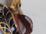 a close up of a vase with a bird on it