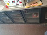 a refrigerator with a bunch of bottles on top of it