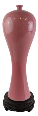 a pink vase with a black base on a white background