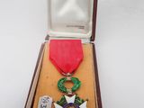 an image of a medal in a box with a ribbon