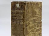 an old book sitting on top of a table next to a white background