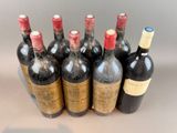 several bottles of wine are lined up in a row on a table
