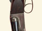 an old gun with a leather case and a metal handle