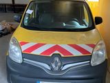 yellow and grey van with red and white stripes parked in a garage