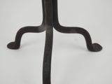 an iron table with a wooden top on a white surface