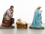 three figurines of jesus and a baby jesus in a manger