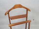 a wooden coat rack with two hangers on it