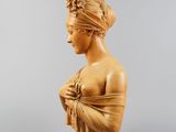 a wooden busturine of a woman wearing a head scarf