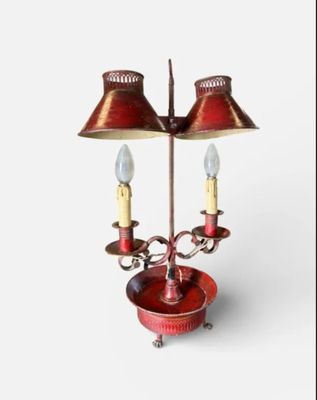 a red table lamp with two lamps on top of it