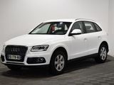 Le SUV Audi blanc est garé dans une pièce au sol carrelé.