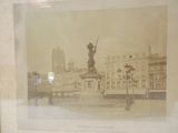 a picture of a picture of a statue in the middle of a city