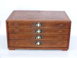 an image of a small wooden box with five drawers