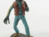 a figurine of a man on a skateboard on a white surface