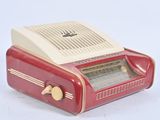 a red and white radio sitting on a white surface