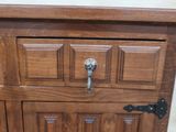 a wooden cabinet with a drawer on top of it
