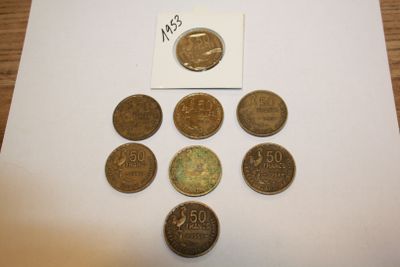 several coins are arranged in a triangle on a table