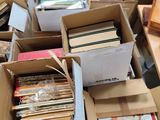 many boxes of books on a table in a room
