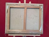 an old wooden easel with a painting on it and a red background