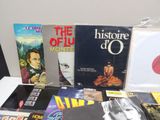 a lot of books on a table with cd ' s on it