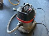 an image of a vacuum on the floor of a garage