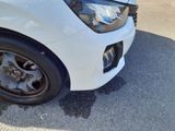 the front end of a white car with a denting dent