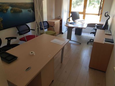 an image of a home office with a desk and chairs